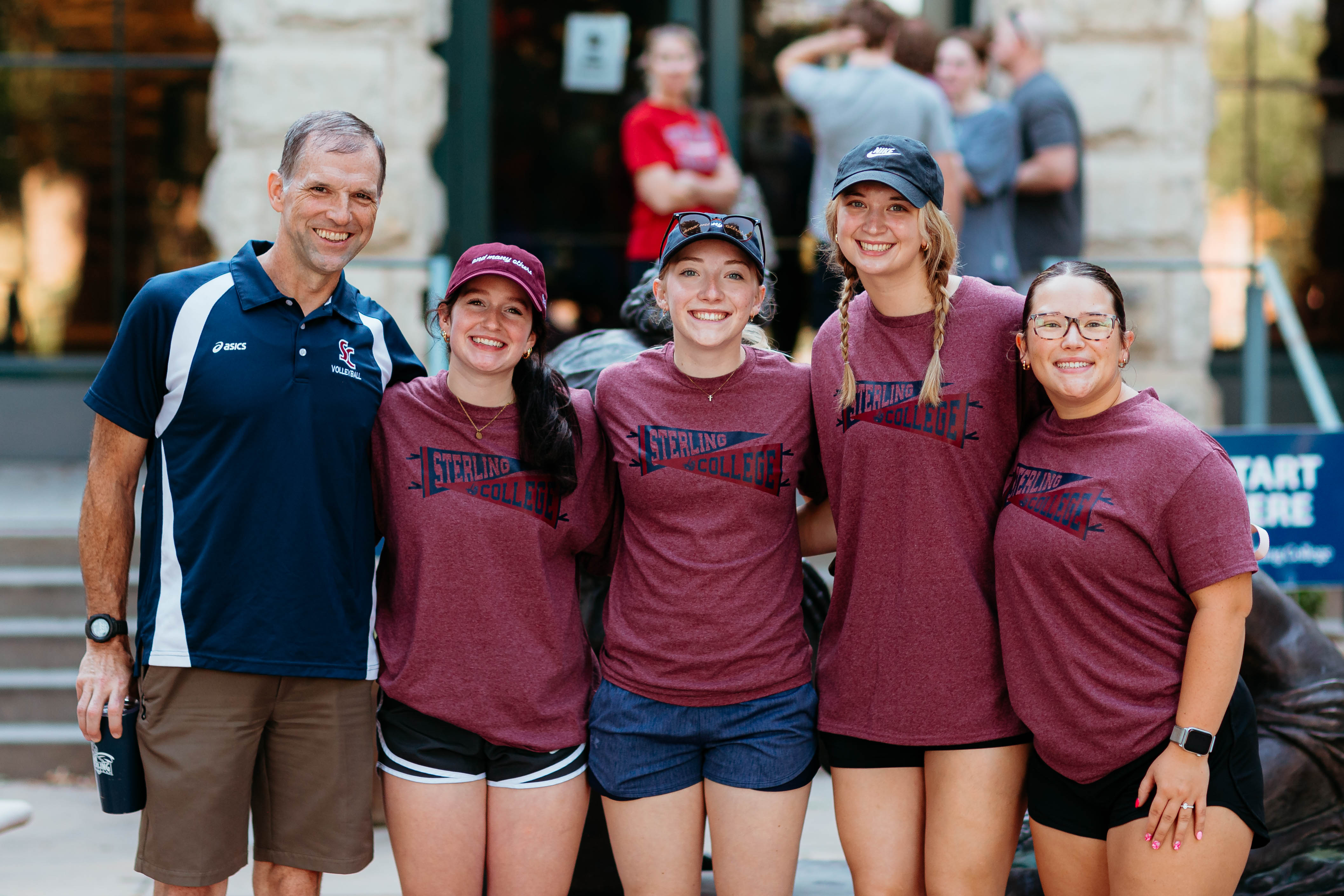 Five people smiling at the camera