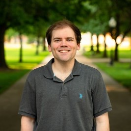 Man dressed nicely smiling at the camera