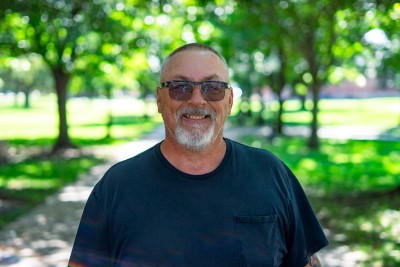 Man dressed nicely smiling at the camera