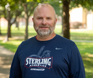 Man standing outside smiling at the camera