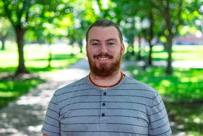Man dressed nicely smiling at the camera