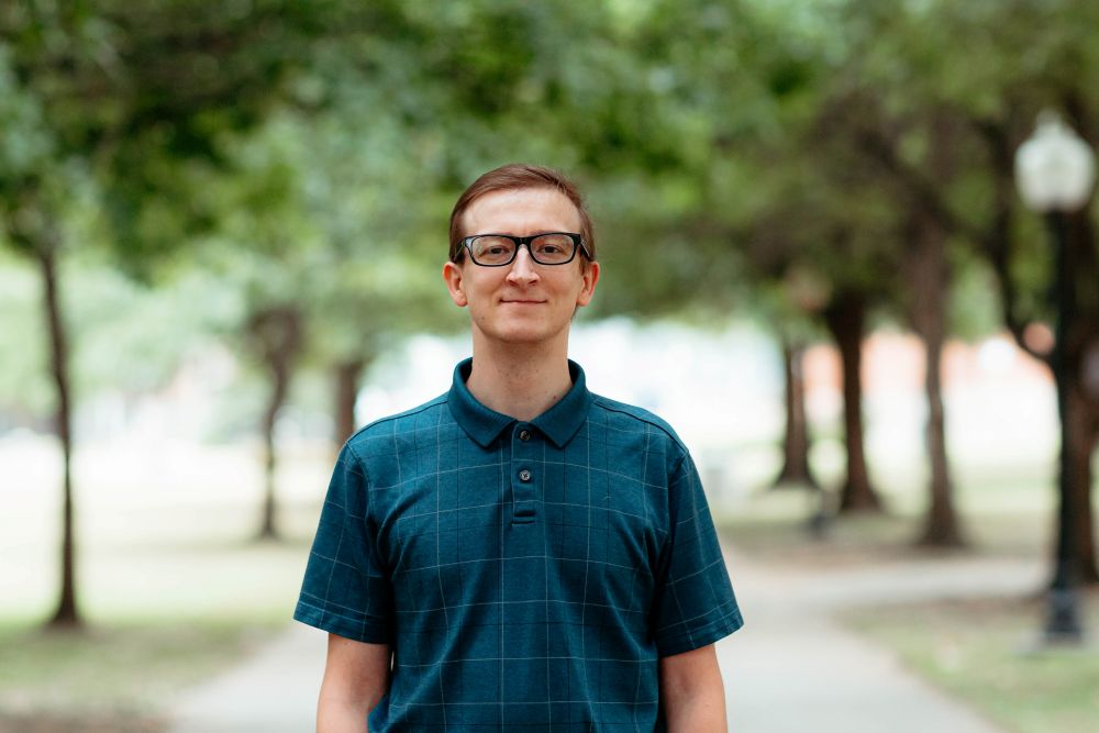 Man dressed nicely smiling at the camera