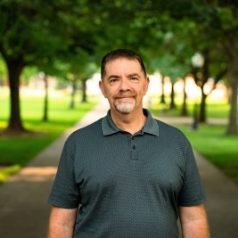 Man dressed nicely smiling at the camera