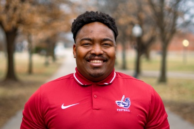 Man dressed nicely smiling at the camera