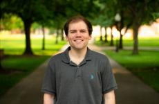 Man dressed nicely smiling at the camera