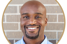 Man dressed nicely smiling at the camera