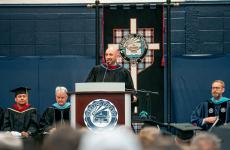 Man speaking at a podium to a group of people