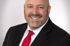 Man dressed nicely smiling at the camera