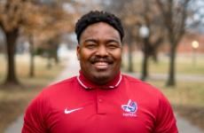 Man dressed nicely smiling at the camera