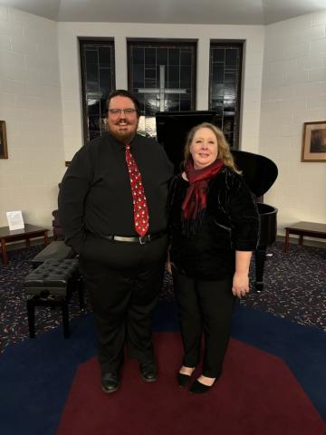 Man and Woman dressed nicely smiling at the camera