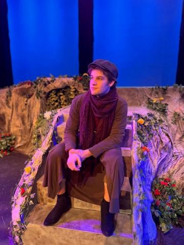 Man sitting on stage during theatre rehearsal 