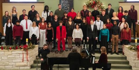 Choir singing on stage in a church