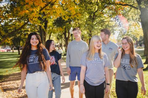 6 people standing on a sidewalk looking at the camera 6 people standing on a sidewalk looking at the camera