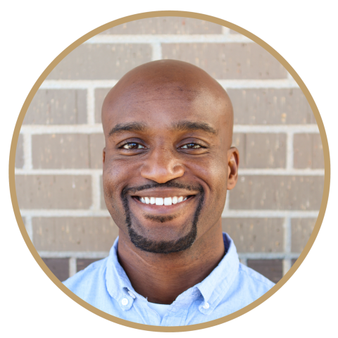 Man dressed nicely smiling at the camera