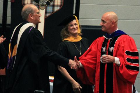 Dr. Maurer bestows the Klings with the honor of faculty emeriti at commencement. The Klings were given the honor of faculty emeriti at commencement.