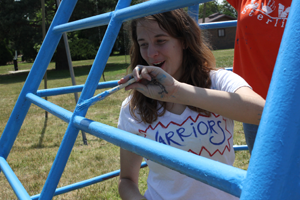 Freshman Stephanie Smith helps paint playground equipment during Love Sterling.