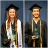 two students wearing graduation attire and holding glass awards