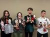 Four students holding Christmas nutcrackers
