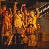 theatre students posing for the finale of a song with their hands in the air